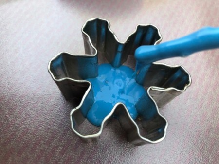 Homemade Window Clings - place a cookie cutter on the plastic sheet and using a paint brush drip some of the mixture inside the cutter