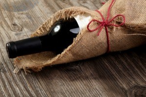 Bottle of wine wrapped in burlap.