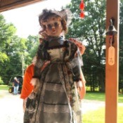 Value of an Ashley Belle Doll - doll wearing a gray dress with horizontal lace