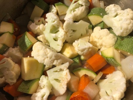 cauliflower and zucchini added to pot