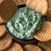 Spinach Dip surrounded by crackers.