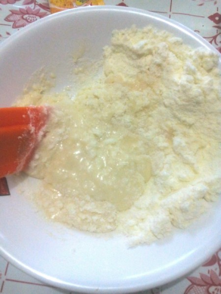 adding milk to powdered sugar