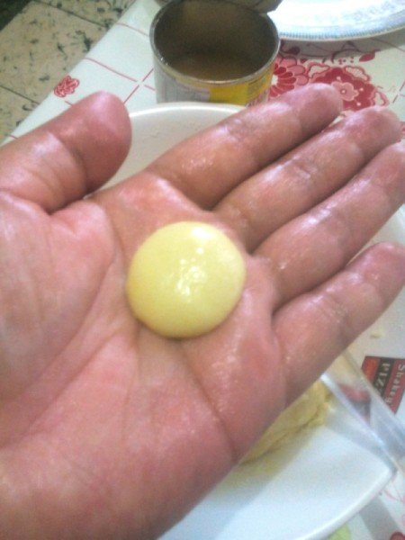 ball of dough on buttered hand