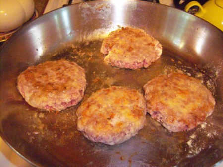 steaks cooking in pan