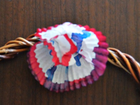 Color Explosion Summer Wreath - fold liners in half, then pinch and ruffle up to create the flowers, hot glue to the wreath