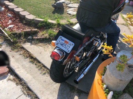A homemade sissy bar on the back of a motorcycle.