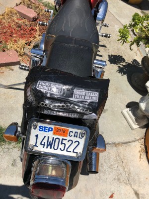A homemade sissy bar on the back of a motorcycle.
