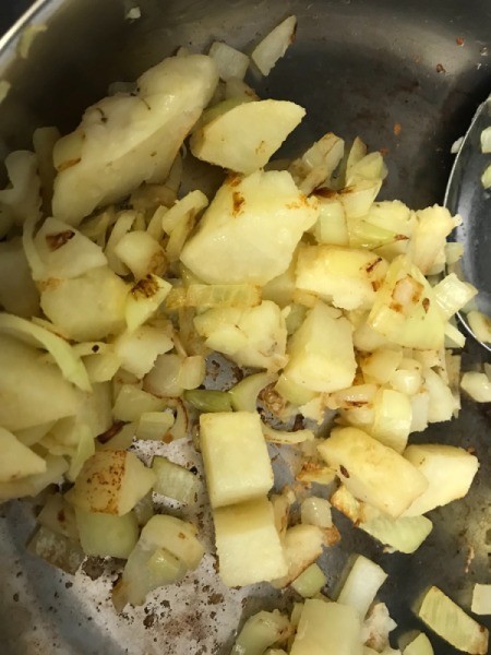 onions, garlic and potato in pan