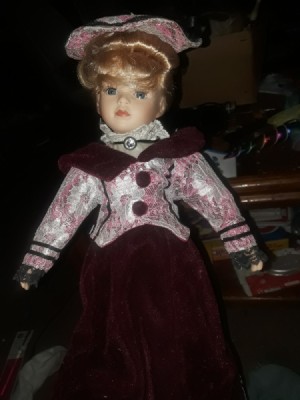 Identifying a Porcelain Doll - doll wearing a dark red dress with a floral jacket