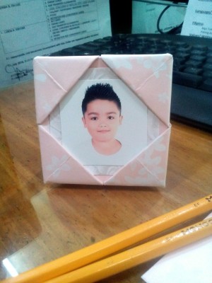 Folded Paper Photo Frame - pink and white folded paper photo frame with a child's photo in place