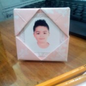 Folded Paper Photo Frame - pink and white folded paper photo frame with a child's photo in place