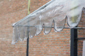 Clear awning with brick wall in the background.