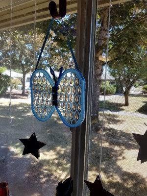 Butterfly Suncatcher Using Unique Lids - hanging in window