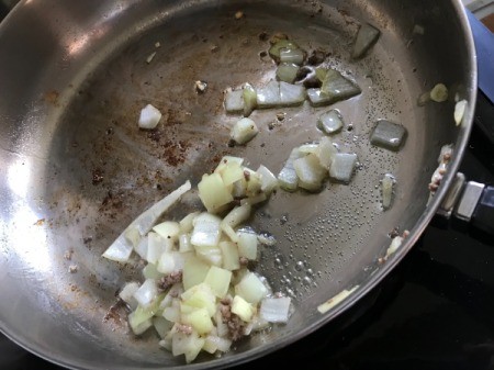 cooking chopped onion in pan