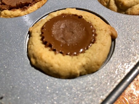 peanut butter cups pressed into muffin tin dough