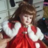 Identifying Porcelain Dolls - doll wearing a red dress and coat with white fur edging