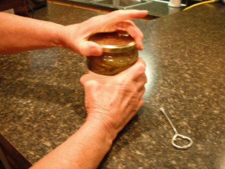 Opening a jar of pickles.