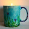 Mug Turned Colorful Candle Holder - candle burning inside the cup
