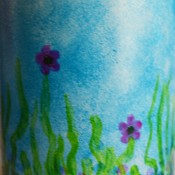 Mug Turned Colorful Candle Holder - mix the emerald and blue glaze to make a darker green and add shadows to the grass shoots and to color the center of the flowers