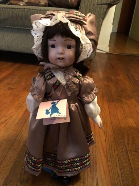 Value of Ashley Belle Doll - doll wearing a brown dress and matching lace edged bonnet
