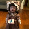 Value of Ashley Belle Doll - doll wearing a brown dress and matching lace edged bonnet