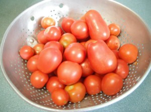 A colander of cherry tomatoes.