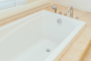 Bathtub surrounded by granite.