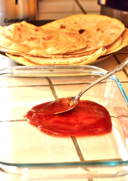 spreading sauce in baking dish