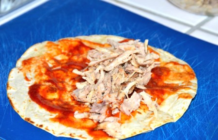 chicken on sauced tortilla