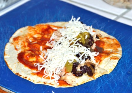 adding cheese to tortilla