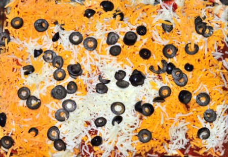 adding olives to casserole