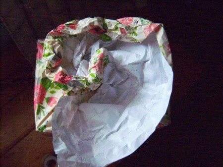 Flower Gift Wrapping - roll the paper under while forming a tighter coli