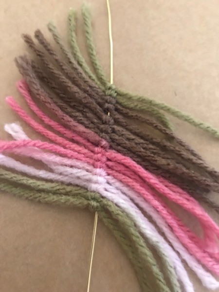 Recycled Cardboard Ring and Yarn Dreamcatcher - closeup of all of the yarn pieces knotted on