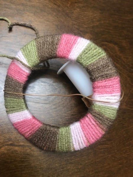 Recycled Cardboard Ring and Yarn Dreamcatcher - begin wrapping wire around the yarn wrapped ring