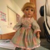 Identifying a Porcelain Doll - doll wearing a pink and blue gingham dress