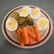 plate with deviled eggs carrots and pickles