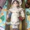 Information on Collectible Memories Porcelain Doll - doll wearing a white outfit in a box