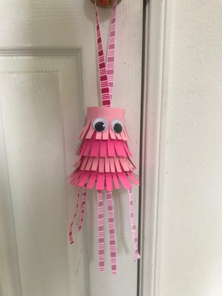 Jellyfish Piñata for Kids - piñata hanging on a door knob