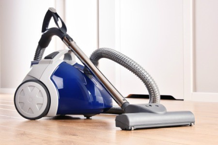 Canister vacuum on a wood floor.