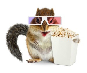 Chipmunk wearing 3D glasses holding a box of popcorn.