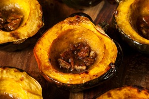 Baked acorn squash halves with pecans.