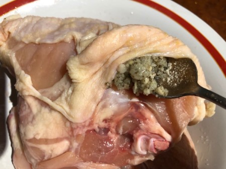 putting herbs and cheese under the skin