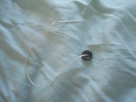 Tufting a Comforter - sew on button by pulling thread through from under side