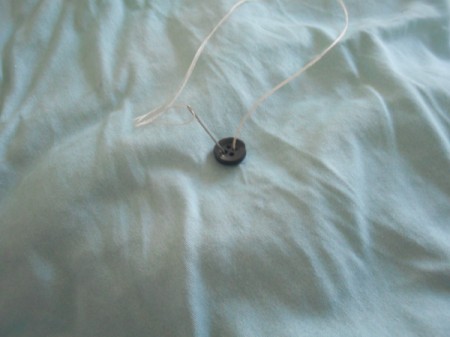 Tufting a Comforter - pull thread through button hole(s) several times