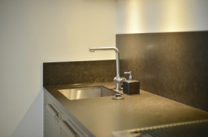 Grey laminate countertop with a sink.