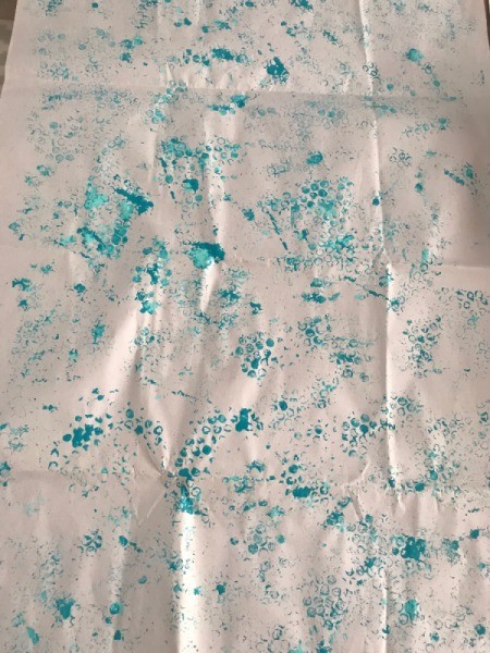 Wrapping Paper and Bow Made from Packaging Items - stamp and repeat adding paint as needed