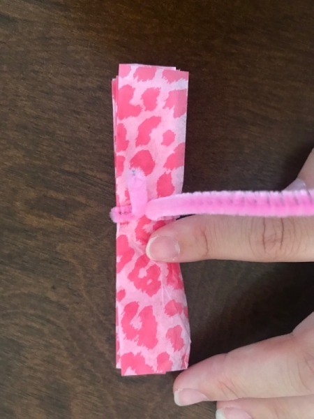 Wrapping Paper and Bow Made from Packaging Items - secure center with a pipe cleaner