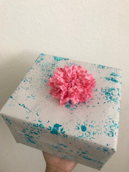 Wrapping Paper and Bow Made from Packaging Items - tape bow to the gift