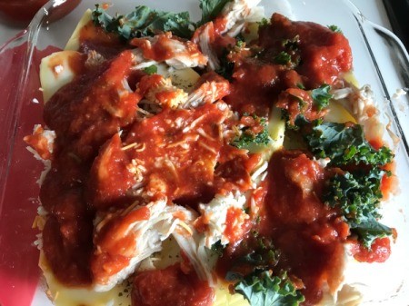 pasta sauce on chicken in casserole