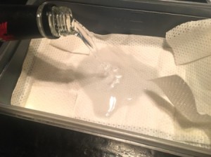 Vodka being poured onto a soft cloth to be used in an ice pack.